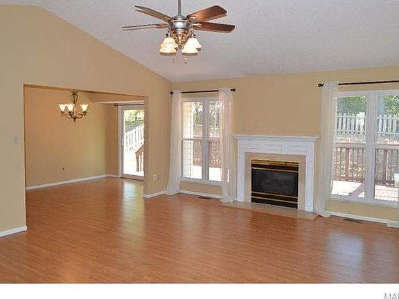 Great Room has vaulted ceiling, gas fireplace, wood laminate flooring and open to dining area.
