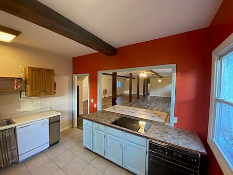 Kitchen, unfurnished. Looking into large main room with redone floors