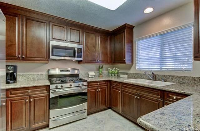 Fully updated kitchen with pine cabinetry, granite counters, sta