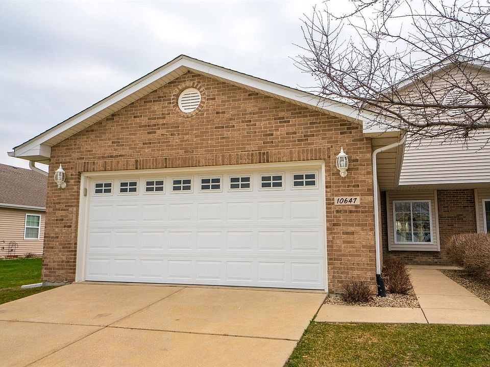 VIEW OF FRONT OF HOME W/BRICK FRONT, CONCRETE DRIVEWAY AND UPGRADED GARAGE DOOR W/WINDOWS!