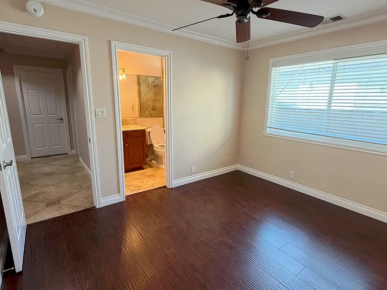 First bedroom with direct access to an en-suite bathroom for added privacy.