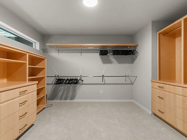 Primary closet with custom cabinetry