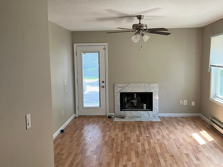 Living room with new central air and heat being installed laminate flooring