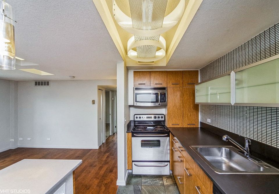 Kitchen with built-in microwave, dishwasher and lovely tiled backsplash
