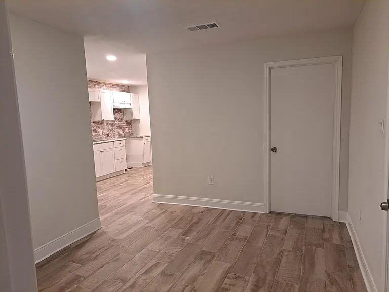Front entrance into living room. Total house wood plank ceramic.