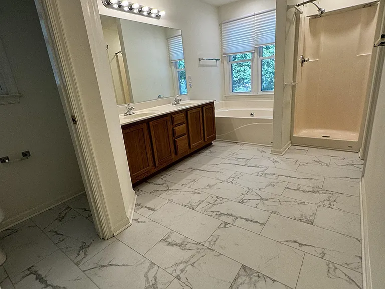 Spacious primary bathroom with separate toilet room.