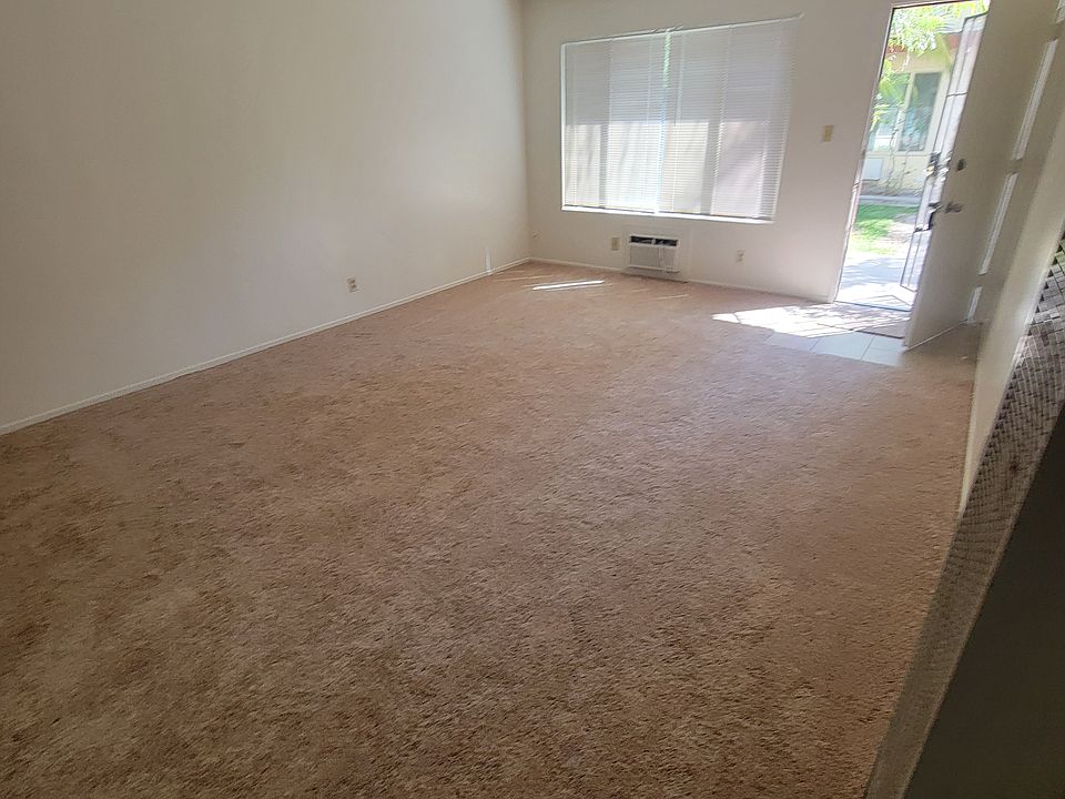 View of living room to front door from kitchen area