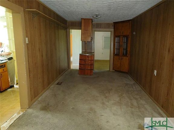 Large dining room with built in storage.  Bedroom 3 is to the right rear.  Bathroom is to left rear.  Kitchen is to the left.
