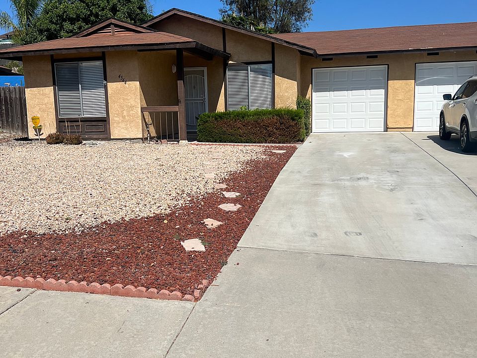 Front view showing driveway, space for two vehicles