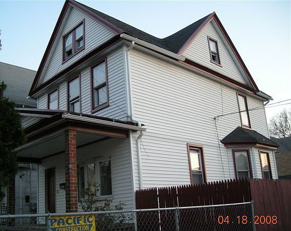 Corner property enclosed back yard and covered front porch, detached garage