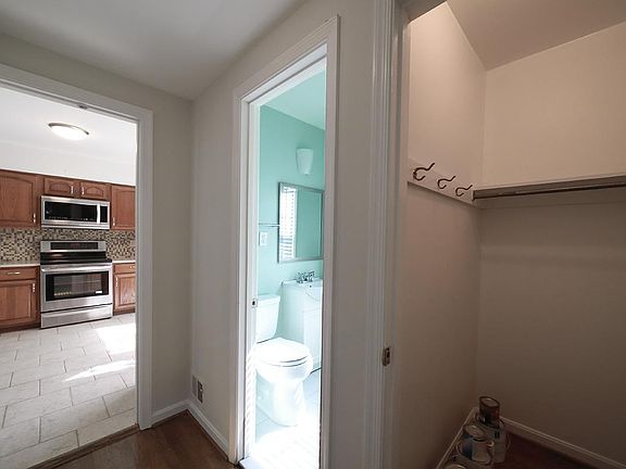 View from Entrance - Large coat closet and BRIGHT powder room on the right. Kitchen straight ahead