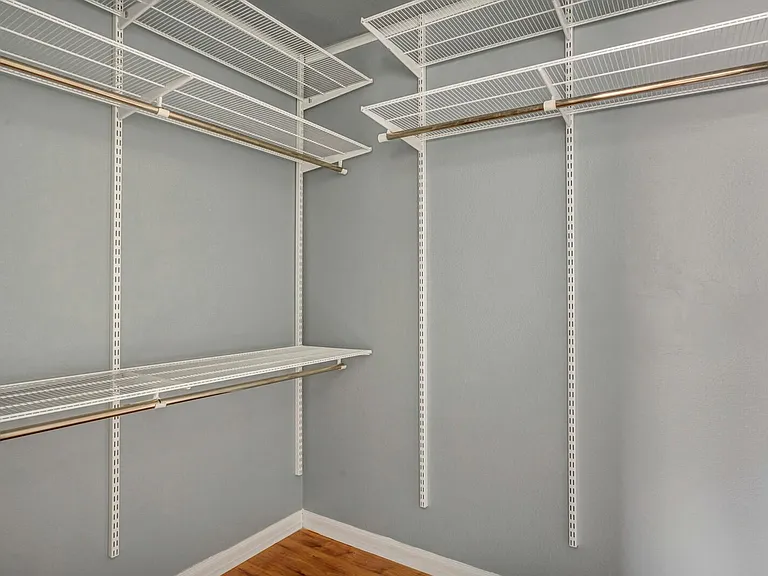 Walk-in closet with pre-built shelves.