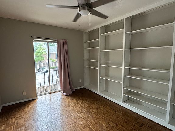 Bedroom 2 with built-in bookshelf and closet