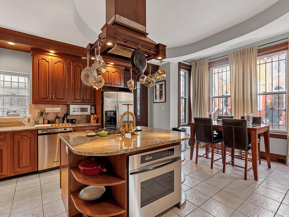 Large eat in kitchen, gas range, and convection oven with view out to Corcoran street.