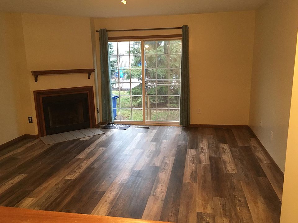 Livingroom area looking through the window from kitchen. Large Clubhouse/pool out the sliding glass door.