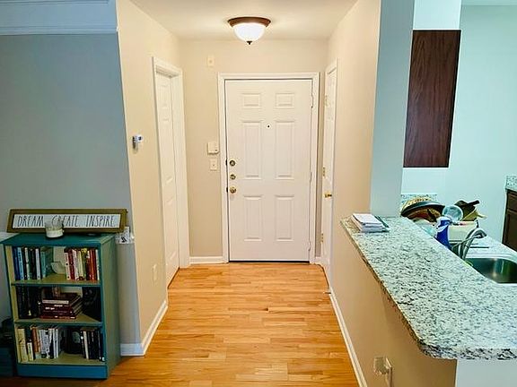 Entrance way with coat closet on right and laundry room on left