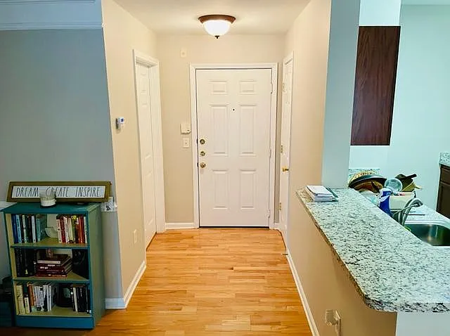 Entrance way with coat closet on right and laundry room on left