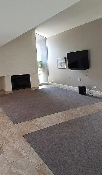 Living Room, TV, Fireplace Courtyard to the left, Dining room to the right.
