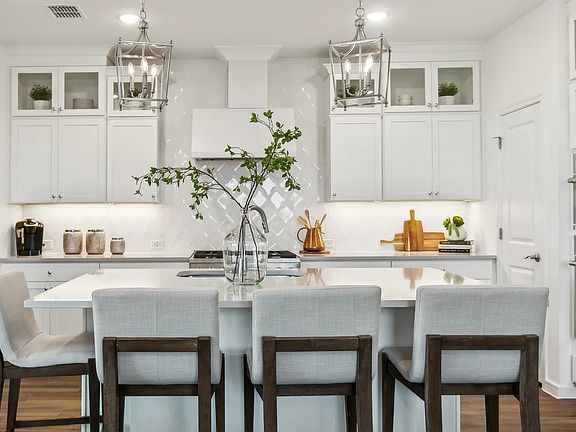 Kitchen with pendant lighting and hexagonal backsplash