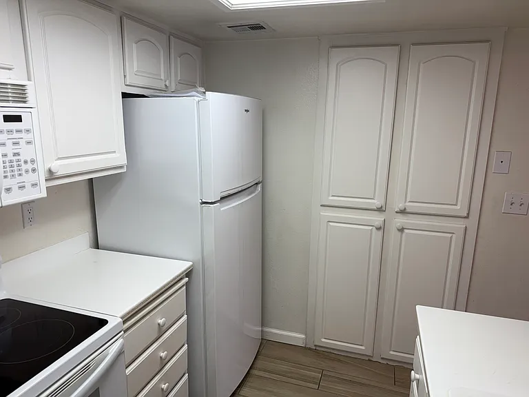 Stprage above oven, refrig. and wall.