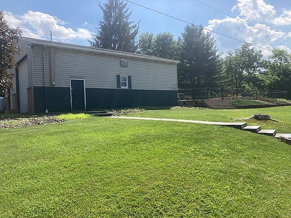 Garage with pool behind it