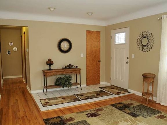 Living room looking at the front door and down the hallway leading to the bedrooms.