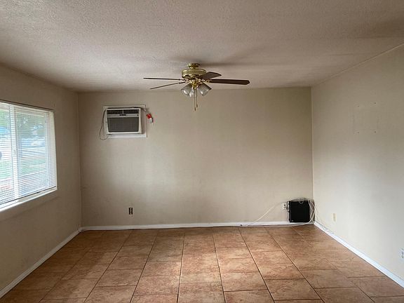 Living Room wall A/C unit and Ceiling fan.