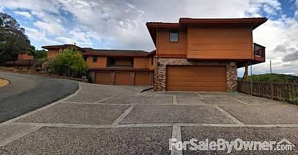 Front View
						:
						Apartment in foreground, main house attached. Additional garage unit below.