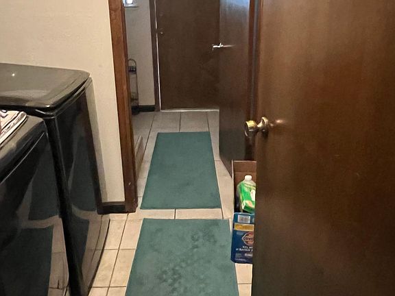 entrance to laundry room, shower, toilet, and entrance to outside pool and spa.