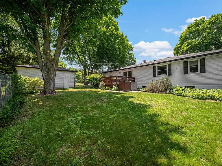 Back view of house, fenced area & detached garage