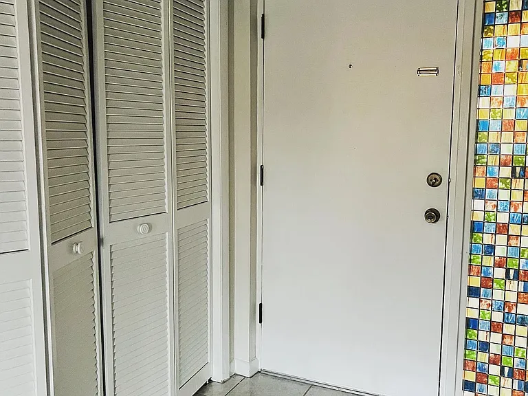 this tile has been replaced with new flooring but was the only interior front door photo I had so I wanted you to see the closet there.
