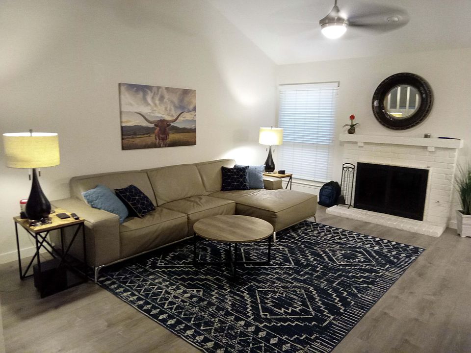 Living room furnished with wood burning fireplace. Available unfurnished as well!