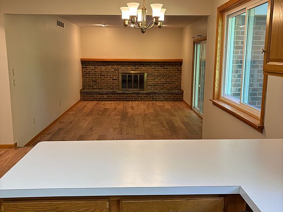 Kitchen looking out into the family room with fireplace
