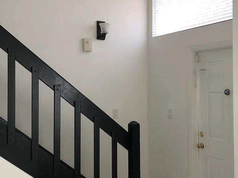 Interior front door and stairs to second floor of the unit,