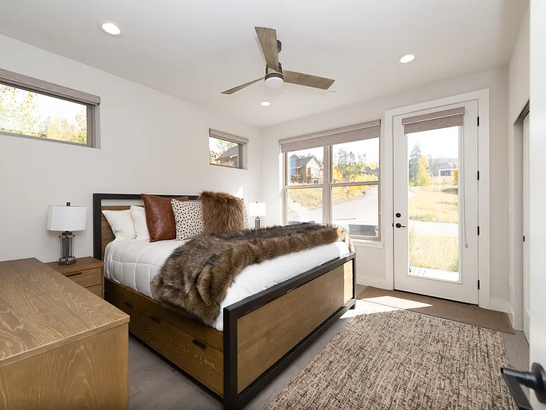Spacious primary suite on the main level featuring elegant finishes and direct access to the private hot tub for ultimate relaxation!