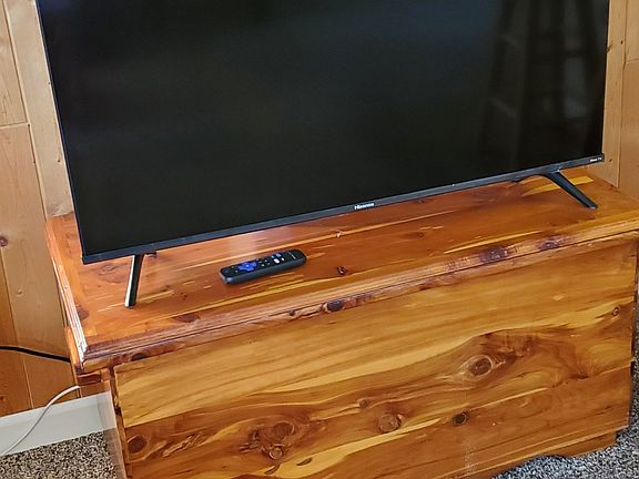 New 40" Smart TV on cedar chest. Chest can be used for storage.