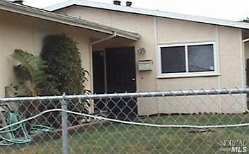 front view.  house is completely fenced