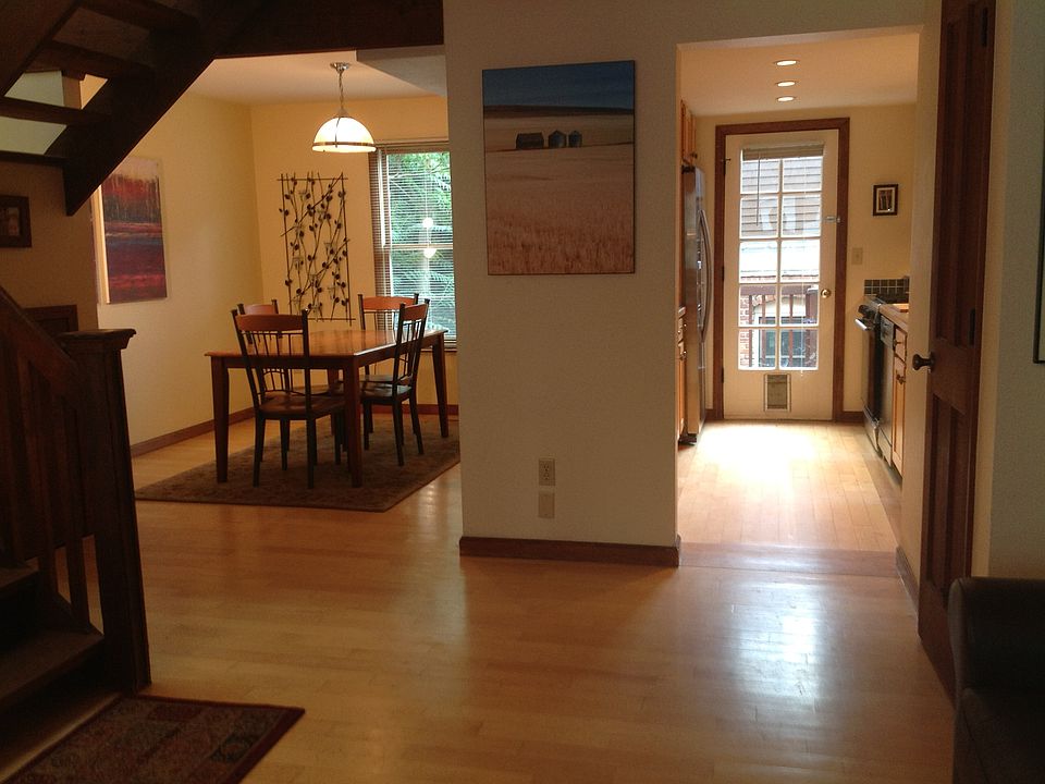 View from vaulted ceiling living room into dining room and kitchen.