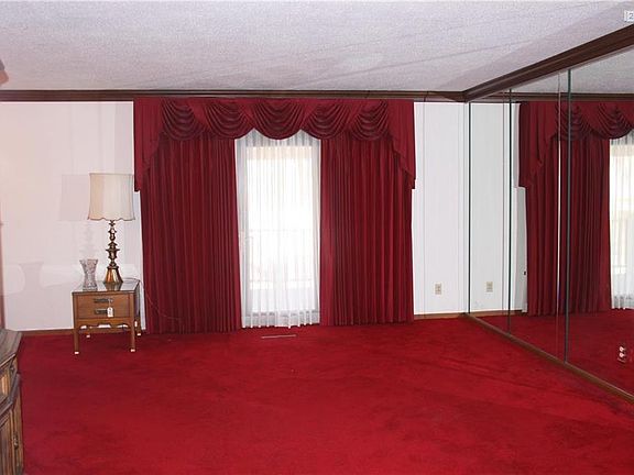 Formal living room. Sliding door leads to covered deck, overlooking pool.