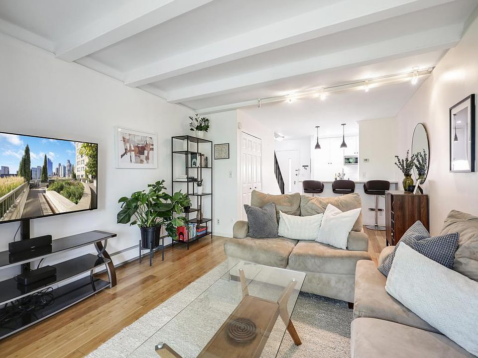 First floor features a spacious living room, fully renovated kitchen and private balcony.