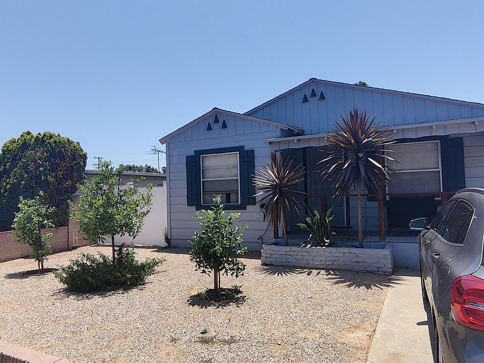 Home entrance, Front yard, patio, and designated parking space on driveway.