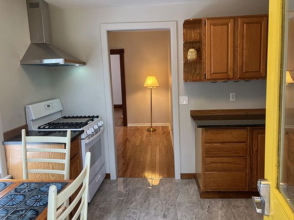 A chef's kitchen awaits. Enter into the recently renovated kitchen with granite countertops, ceramic floor tile, and stainless hood vent over stove and oven.