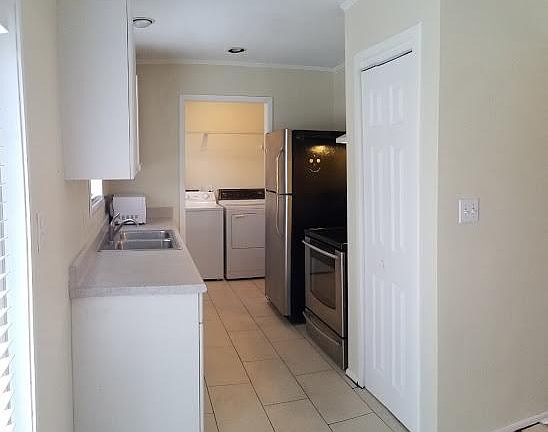 kitchen with laundry in background