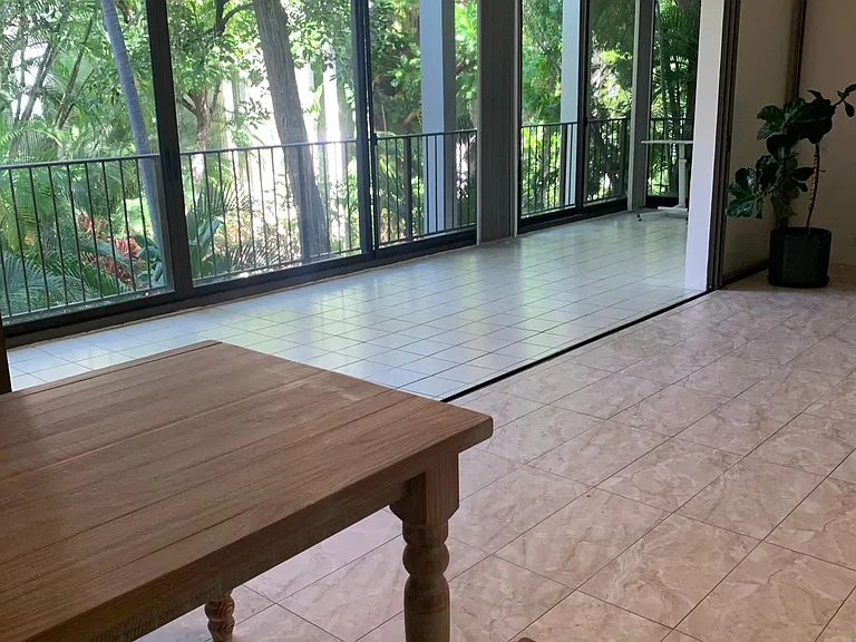 View of dining table looking out to the enclosed lanai_
