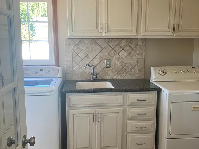 Laundry room with washer and dryer, storage and pantry.