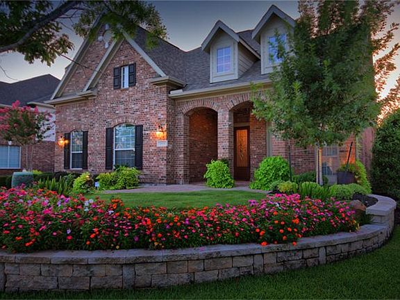 Beautiful covered front porch plus extended paver stone patio/porch areas