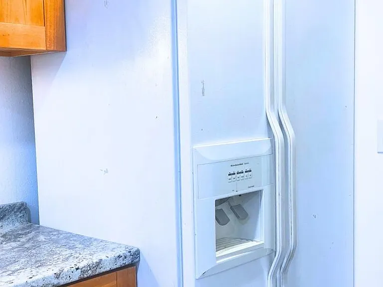 Downstairs kitchen large refrigerator with ice/water door dispenser