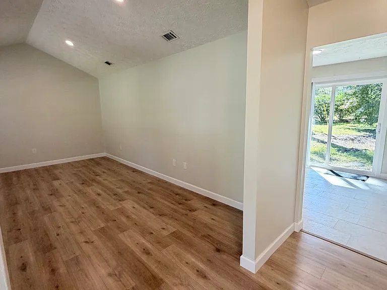 Entry looking left into living room, to the right kitchen entry
