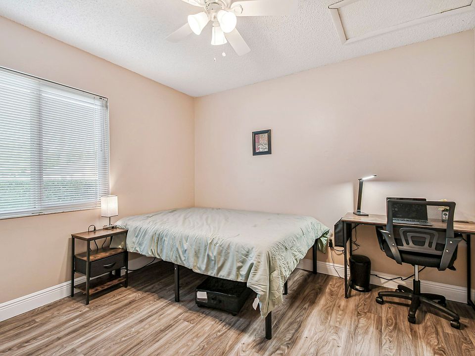 Full size cozy full size bed, with end table, light, desk, office chair and light, storage container under the bed and close