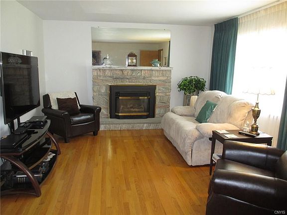 living room with gas fireplace with Arizona quartz surround